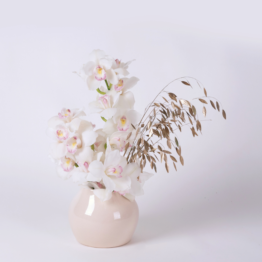 Orchid Twinkle | White Orchid & Gold foliage flower arrangement