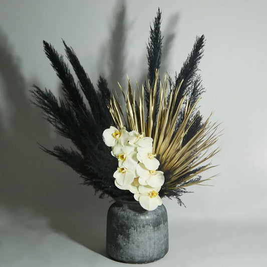 black pampas gold leaves and yellow orchid flower arrangement