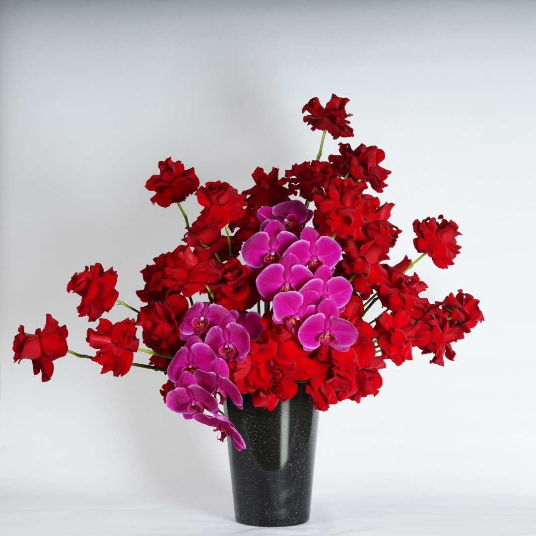 red roses and orchids flower arrangement